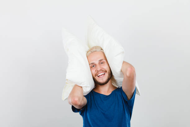 istock Man playing with pillows, good sleep concept 694224478
