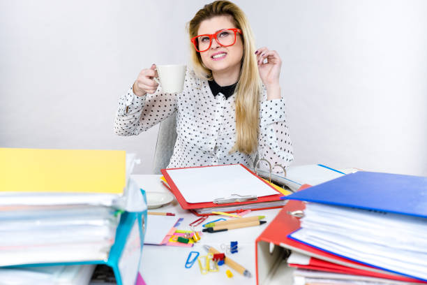 istock Happy woman at office drinking hot coffee 694227294