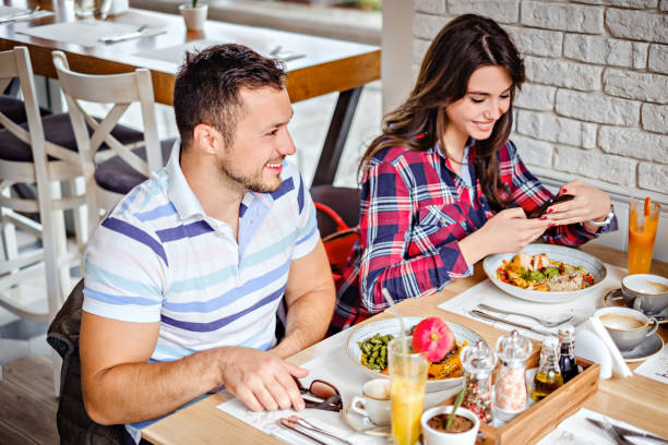 istock Man smiling at the lunch while sitting beside girl 694237194