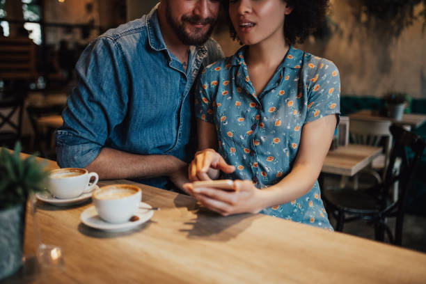 istock Couple at the bar is using a mobile phone 694237782