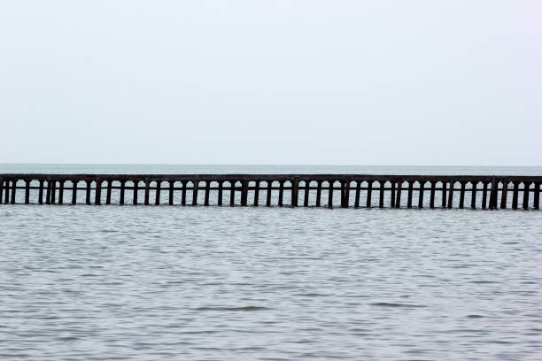 istock Long empty pier against sea horizon - abstract sea background 694244156