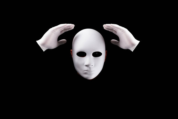 Mysterious man with white  mask  and gloves on black background