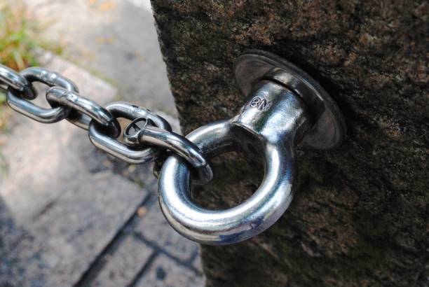 istock Shiny chain fastened to a hook, close up 694253458