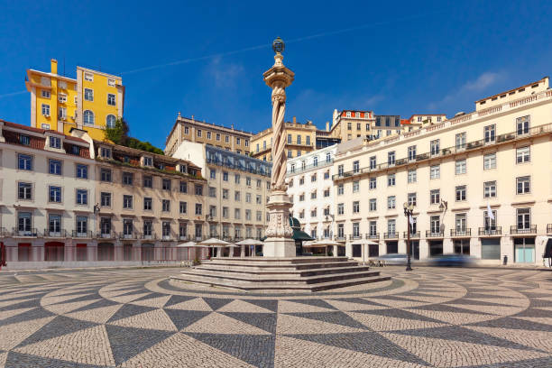 Town Hall Square in Lisbon, Portugal Town Hall Square with a beautiful geometric mosaic in Lisbon, Portugal. In the center of the square the pillory The Pelourinho de Lisboa medieval restraints stock pictures, royalty-free photos & images