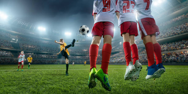 istock Soccer kids player makes a free kick 694271304