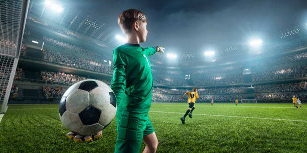 istock Soccer kids goalkeeper in action in 3D dramatic stadium 694271310