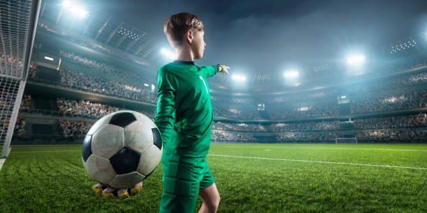 istock Soccer kids goalkeeper in action in 3D dramatic stadium 694271312