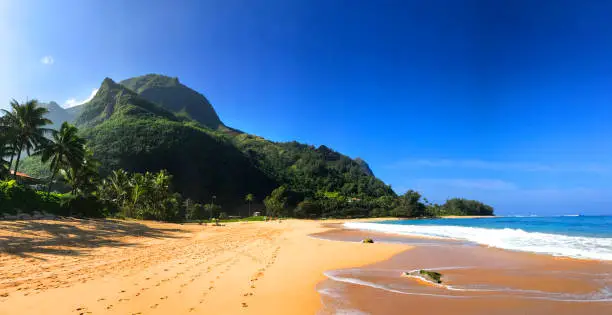 Tunnels Beach with its yellow sand and jungle mountains in Kauai Hawaii