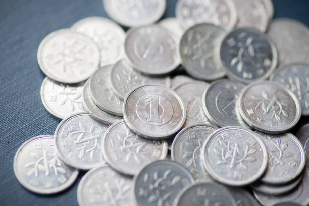 A broken glass jar with scattered coins symbolizes financial instability, economic hardship, or mismanaged savings. It represents themes of money loss, poverty, and financial struggles.