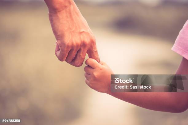 Father And Daughter Holding Hand Together In Vintage Color Tone Stock Photo - Download Image Now