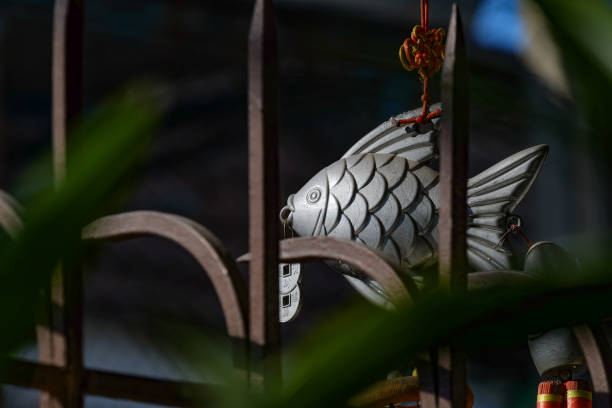 istock Silver fish mobile hang on the red rope with curved sharp steel 694288536