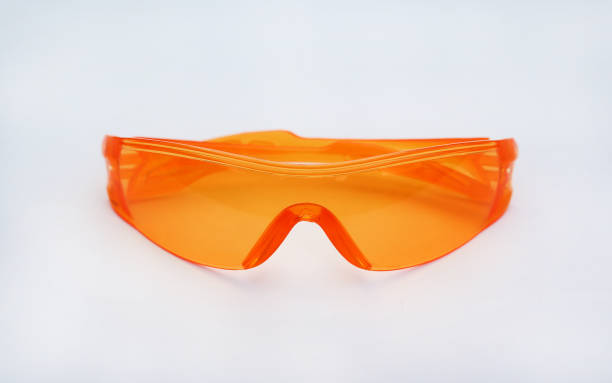 istock Orange safety glasses isolated on white background. 694303350