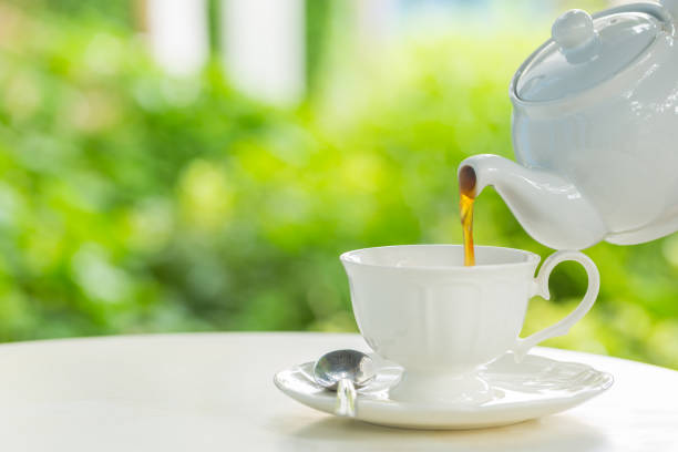istock coffee pot pouring hot coffee into a cup during breakfast in morning sunlight 694303604