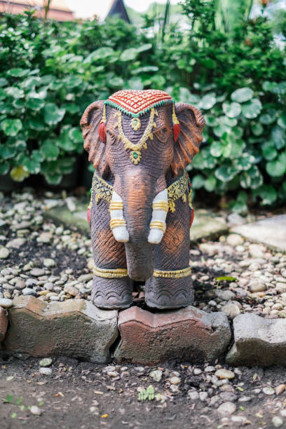 istock Thai elephant doll on the brick with green tree 694307392
