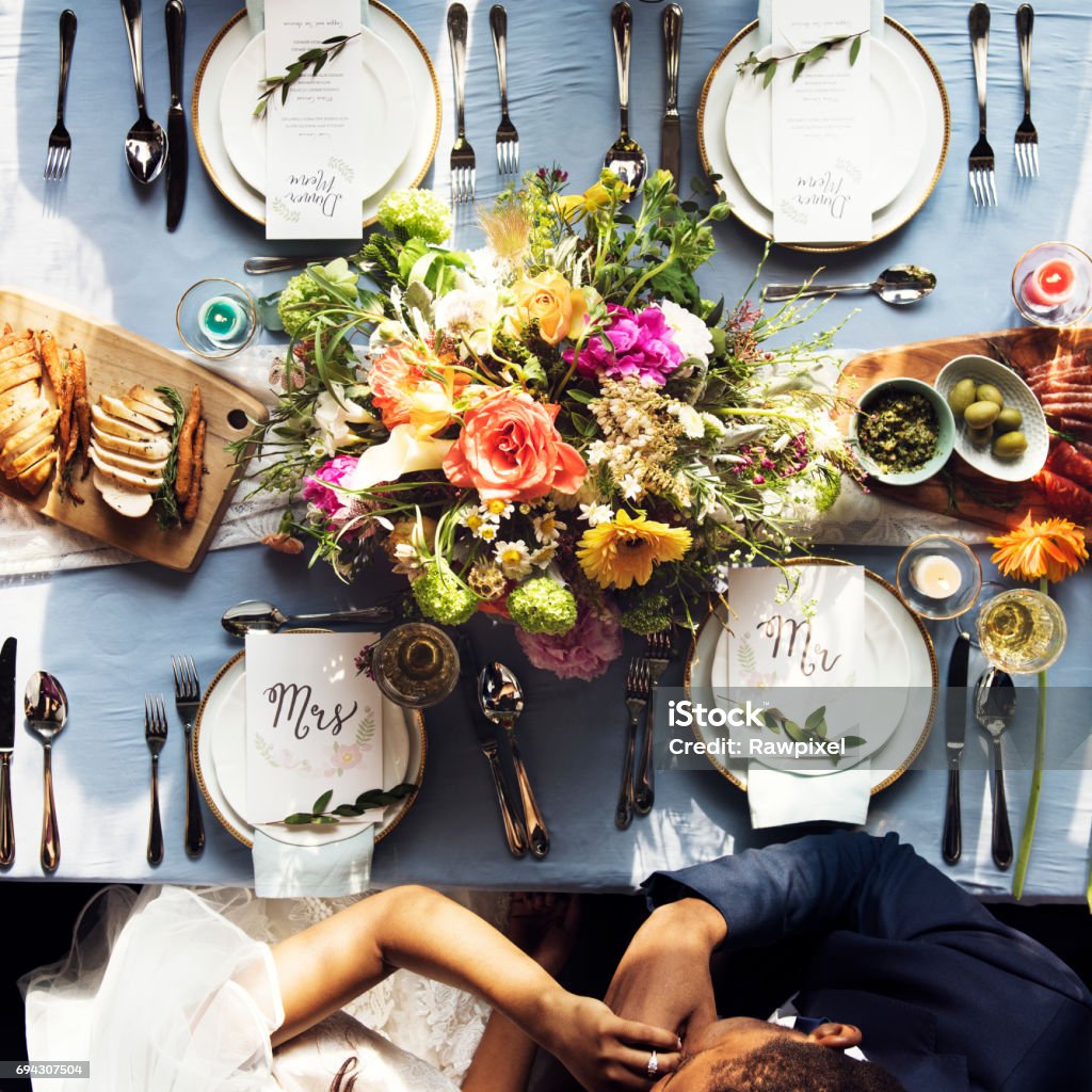 Groom kissing bride hand in wedding reception aerial view Wedding Stock Photo