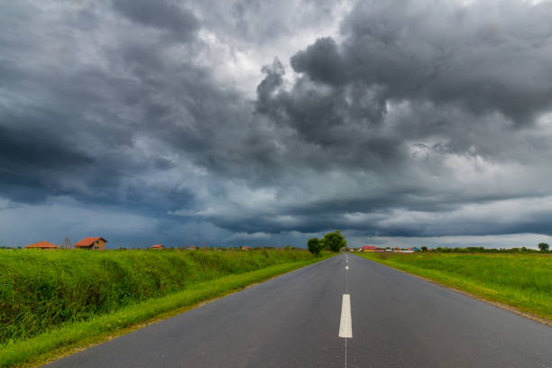 istock Rural area in spring with road and storm clouds 694317012