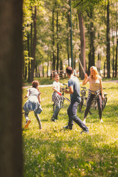 istock Family Playing With Foam Toy Swords 694322732