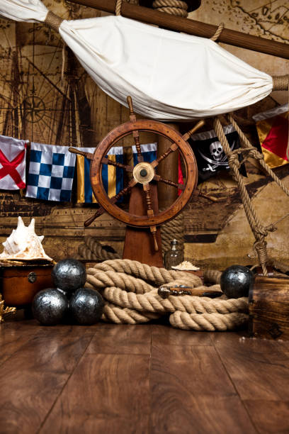 istock Pirates ship deck with steering wheel and flag 694322736