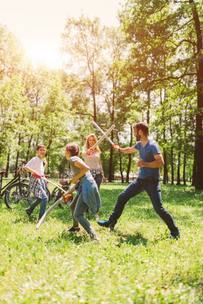istock Family Playing With Foam Toy Swords 694323160