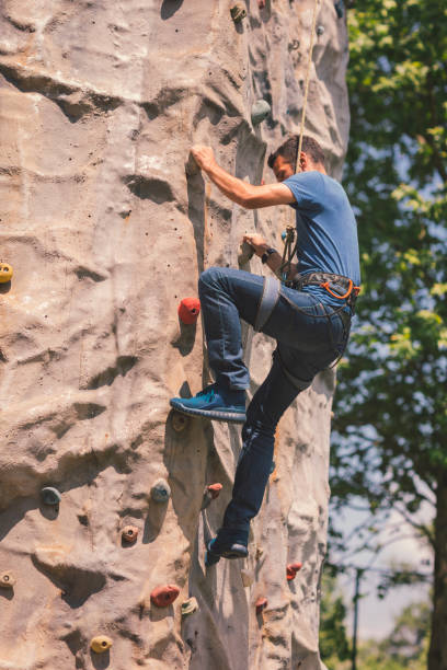 istock Mid adult man on free climbing 694325716