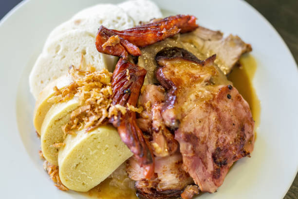 istock Czech traditional cuisine dumplings cabbage and pork meat on a plate. Top view and selective focus 694329010