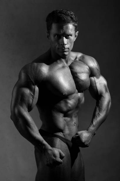 istock Strong athletic man shows beautiful body. 694329562