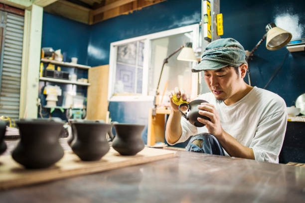 Male ceramic artists making products in studio Mid adult man working in own ceramics Studio pottery making stock pictures, royalty-free photos & images