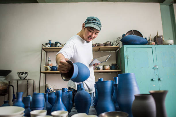 Mid adult man working in own ceramics Studio