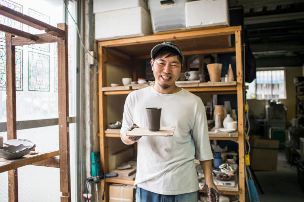 istock Male ceramic artists making products in studio 694329882