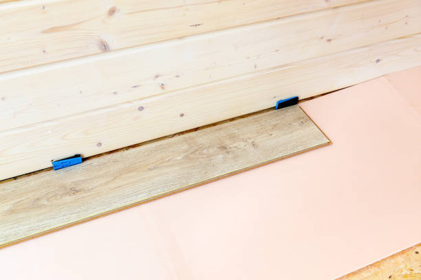 istock Laminate floor installation in the frame house 694330286