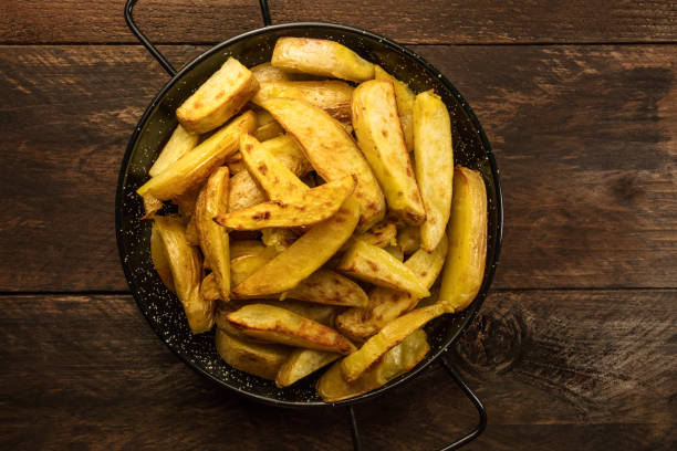 istock Crunchy roasted potatoes in skillet on dark rustic texture 694332970