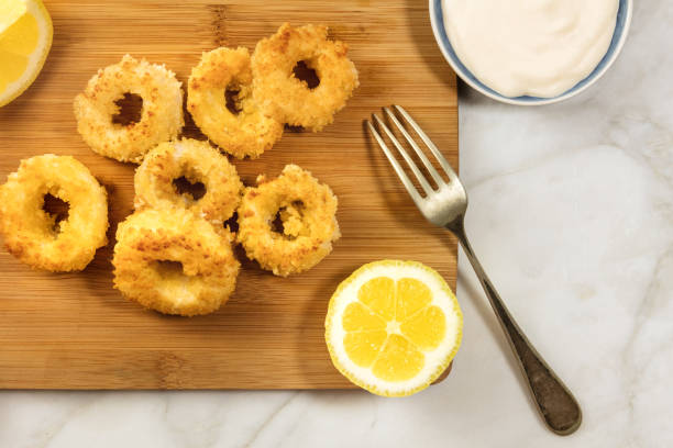 istock Calamari rings, mayonnaise sauce, lemon, copy space 694333006