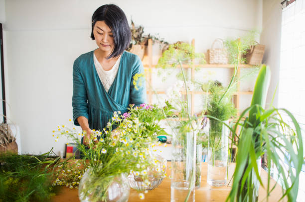 istock Female florist making a herb bouquet in studio 694333200