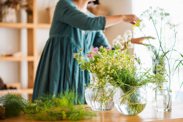 Female florist making a herb bouquet in studio