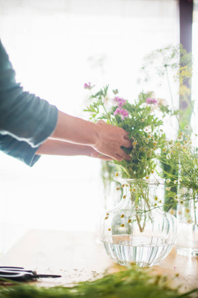 istock Female florist making a herb bouquet in studio 694333210