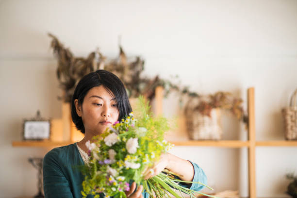 istock Female florist making a herb bouquet in studio 694333222