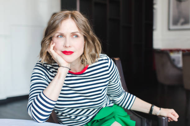 istock Elegant woman sitting confidently 694333894