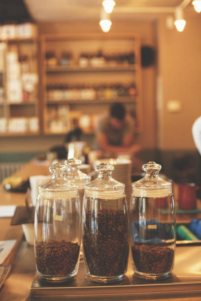 istock Coffee beans in jars at cafe 694335992