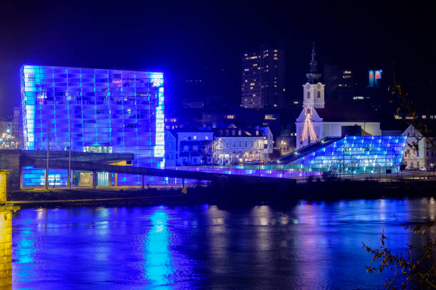 Nightly view over the Danube from the Nibelungenbrücke bridge. Overlooking the river you can see the Ars Electronica Center (AEC), a museum showing the most modern techniques from the technology: this is one of the cultural landmarks of Linz.