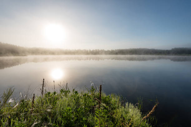 istock reflections in the lake water in the morning mist 694337098