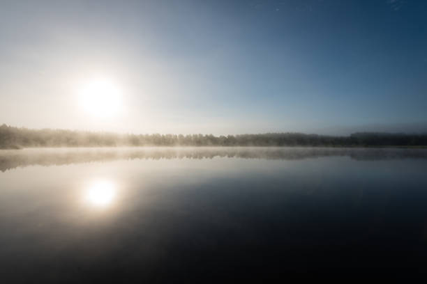 istock reflections in the lake water in the morning mist 694337146