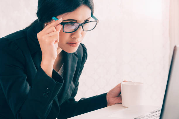 istock Asian Businesswoman working and holding coffee cup in office work space 694337186