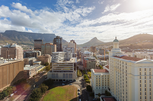 Aerial view to downtown Cape Town Business District with skyscrapers and highrise buildings, underneath famous Table Mountain at the left and Lion's Head at the right. Cape Town, South Africa