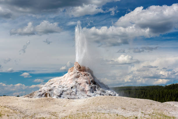istock Geyser erupts with hot water and steam 694344444