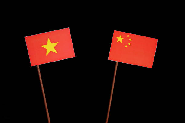 istock Vietnamese flag with Chinese flag isolated on black background 694350808