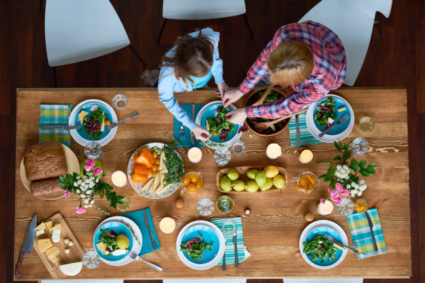 istock Dishing out green salad 694350900