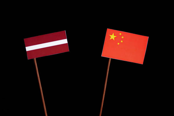 istock Latvian flag with Chinese flag isolated on black background 694351092
