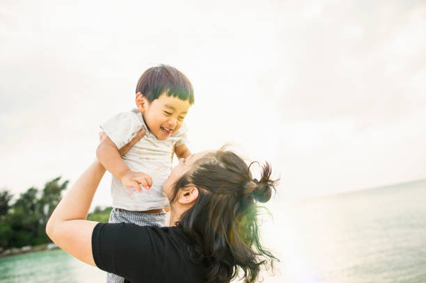 istock Mother and son playing on the beach 694351466