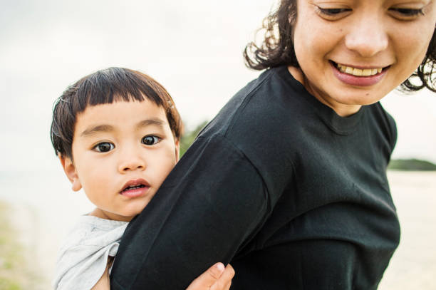 istock Mother and son playing on the beach 694351468