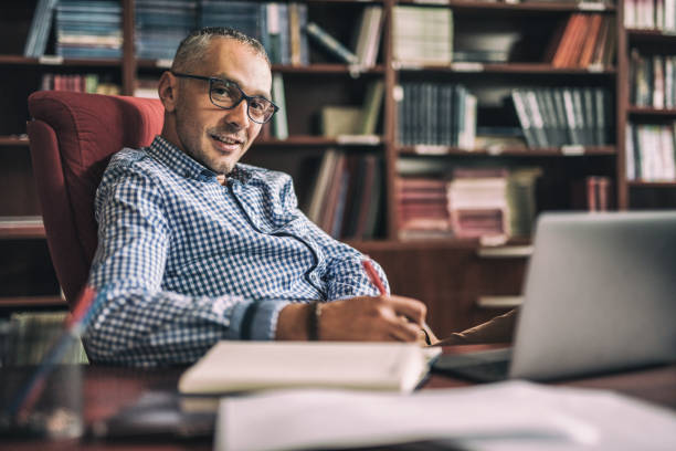 istock Happy mid adult lawyer taking notes in the office. 694351816